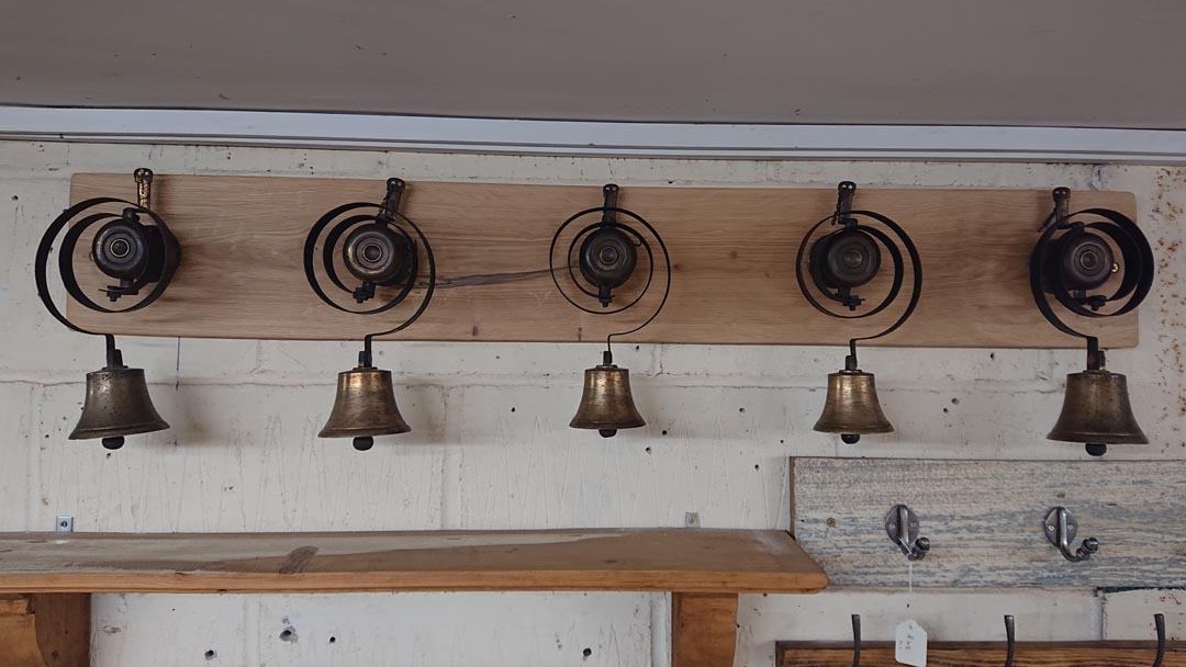 <p>Set of five original servants bell mounted on oak