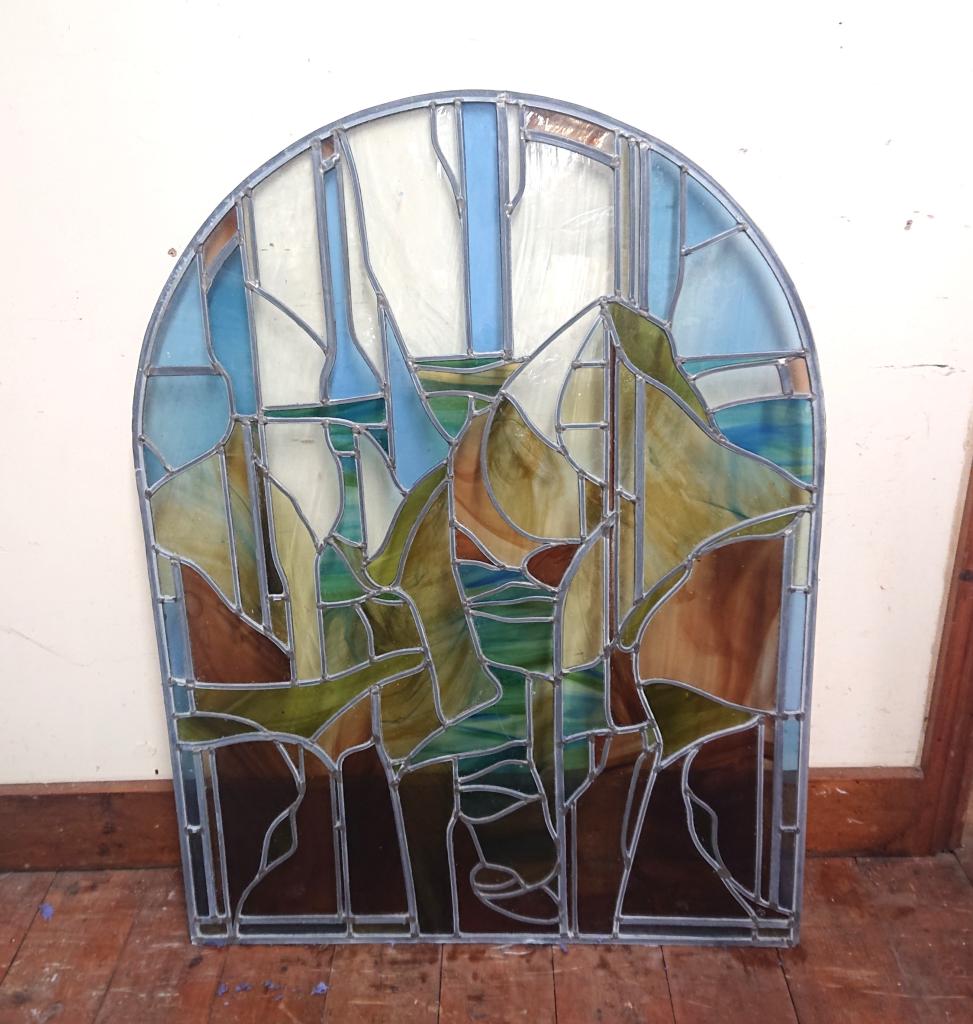 <p>Contemporary leaded arched stain glass window.</p><p>107 cm high x 81 cm wide